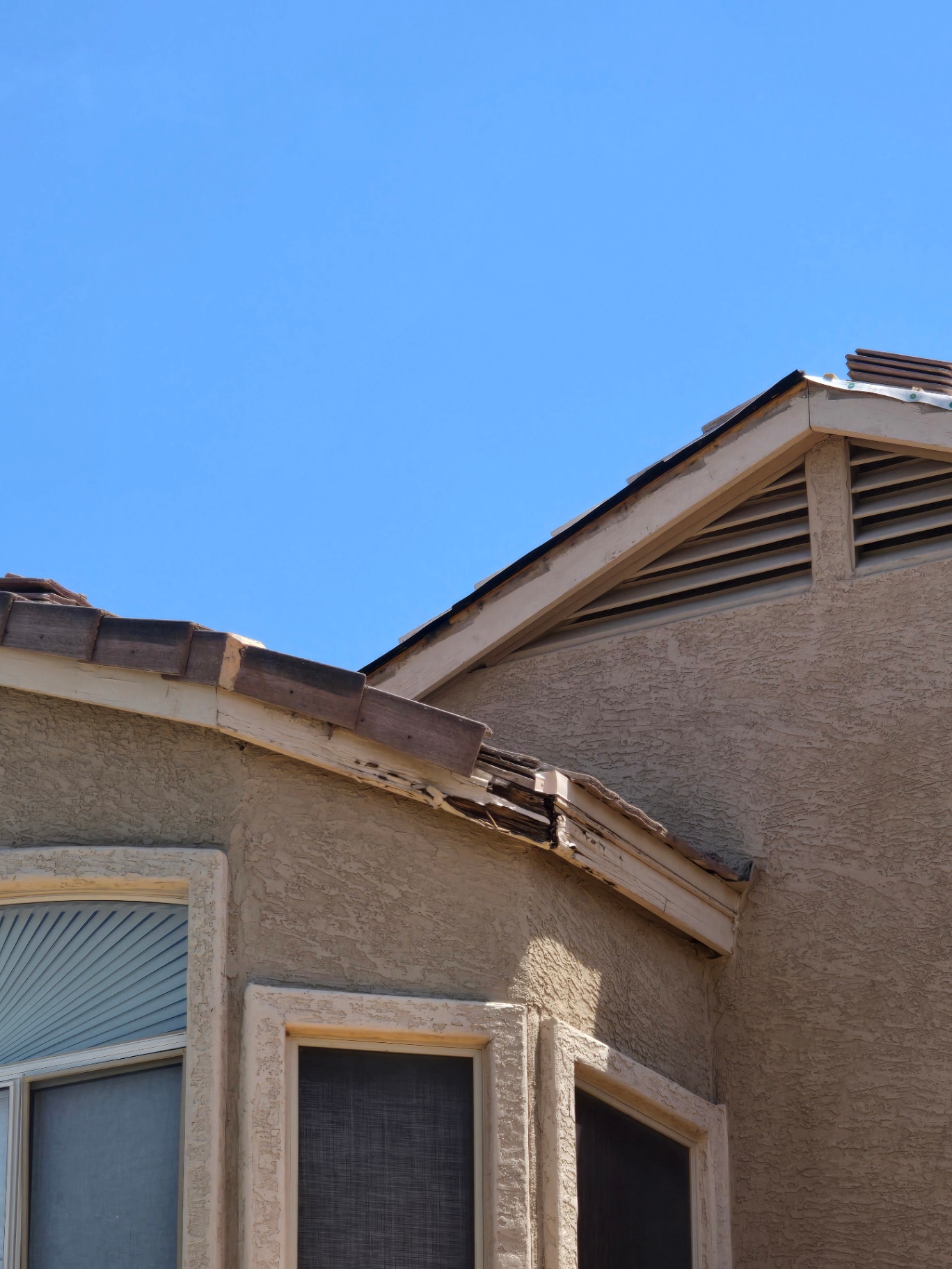 Damaged rake tile and rotted fascia documented before a targeted tile repair