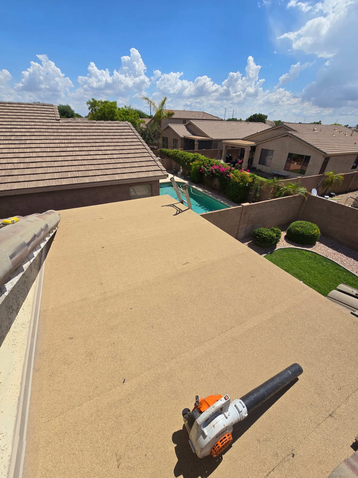Completed patio roof with smooth granulated finish overlooking backyard pool