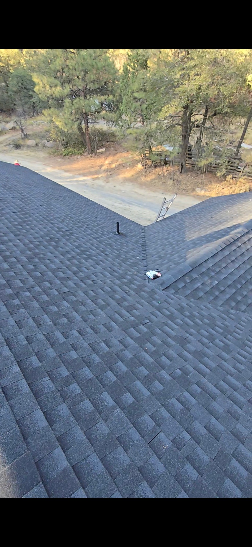 Finished charcoal architectural shingle roof with clean valley detailing