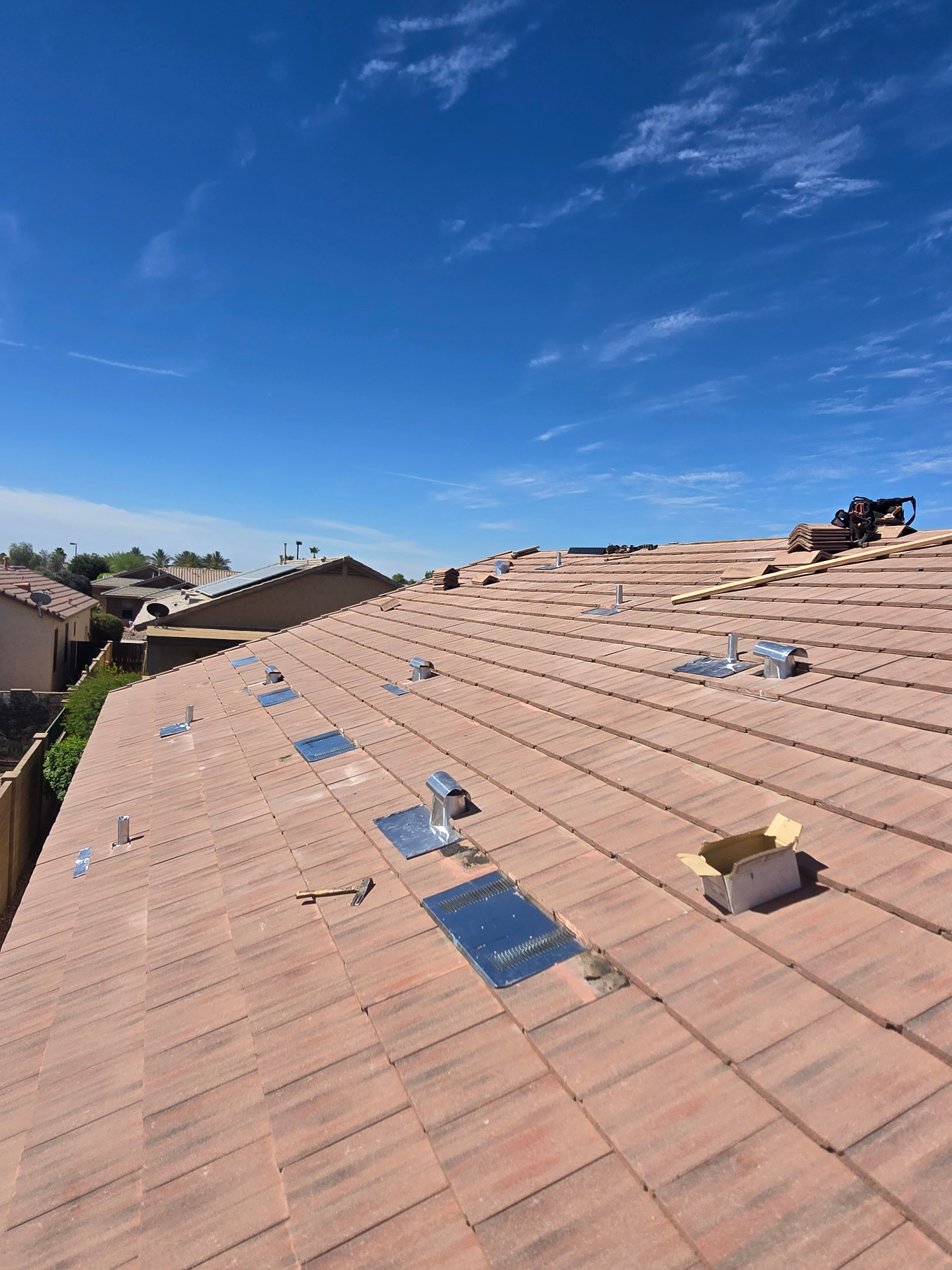 Finished flat concrete tile roof with new vents and flashings