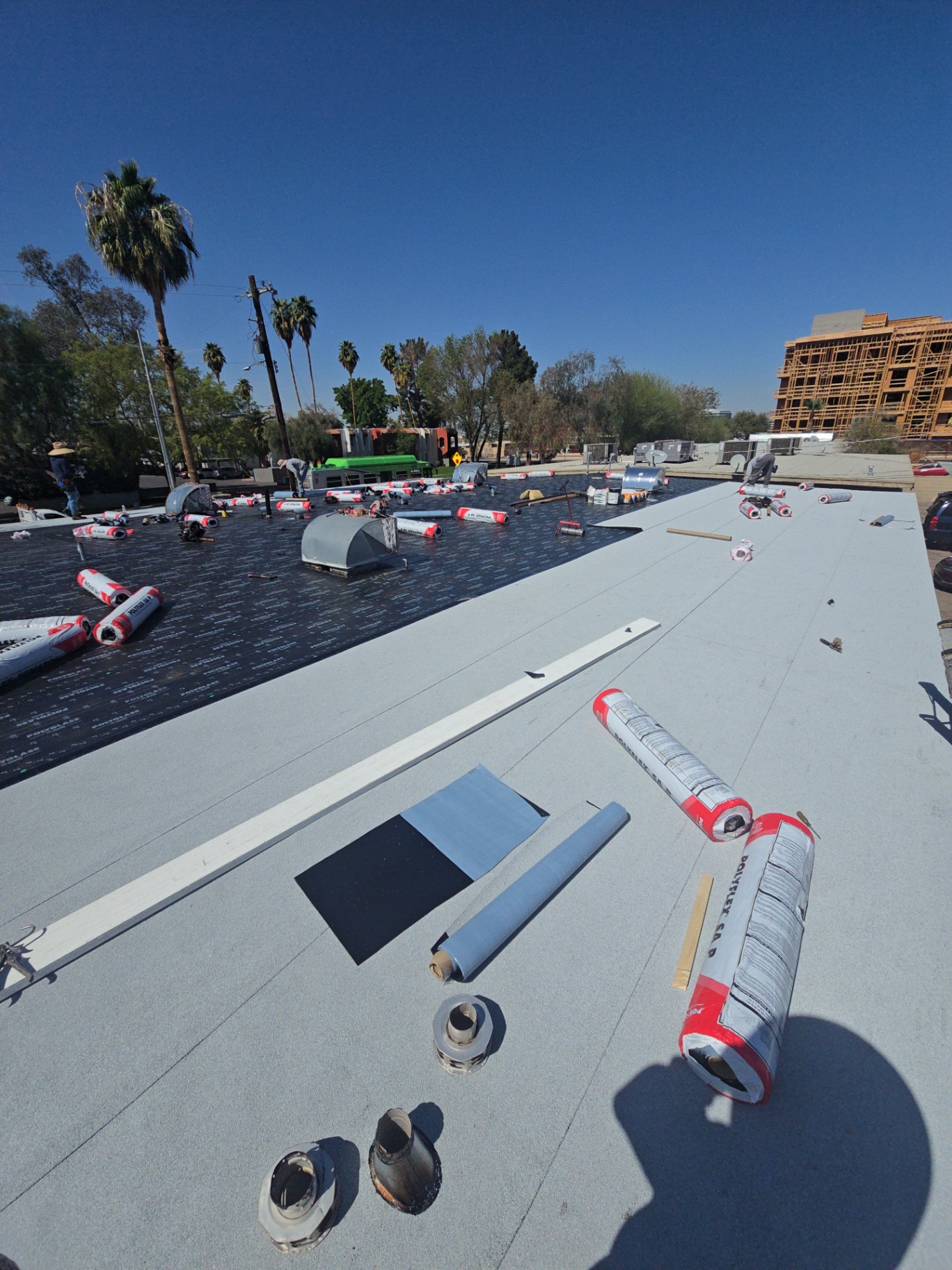 Two-ply modified bitumen flat roof in progress with Polyglass underlayment