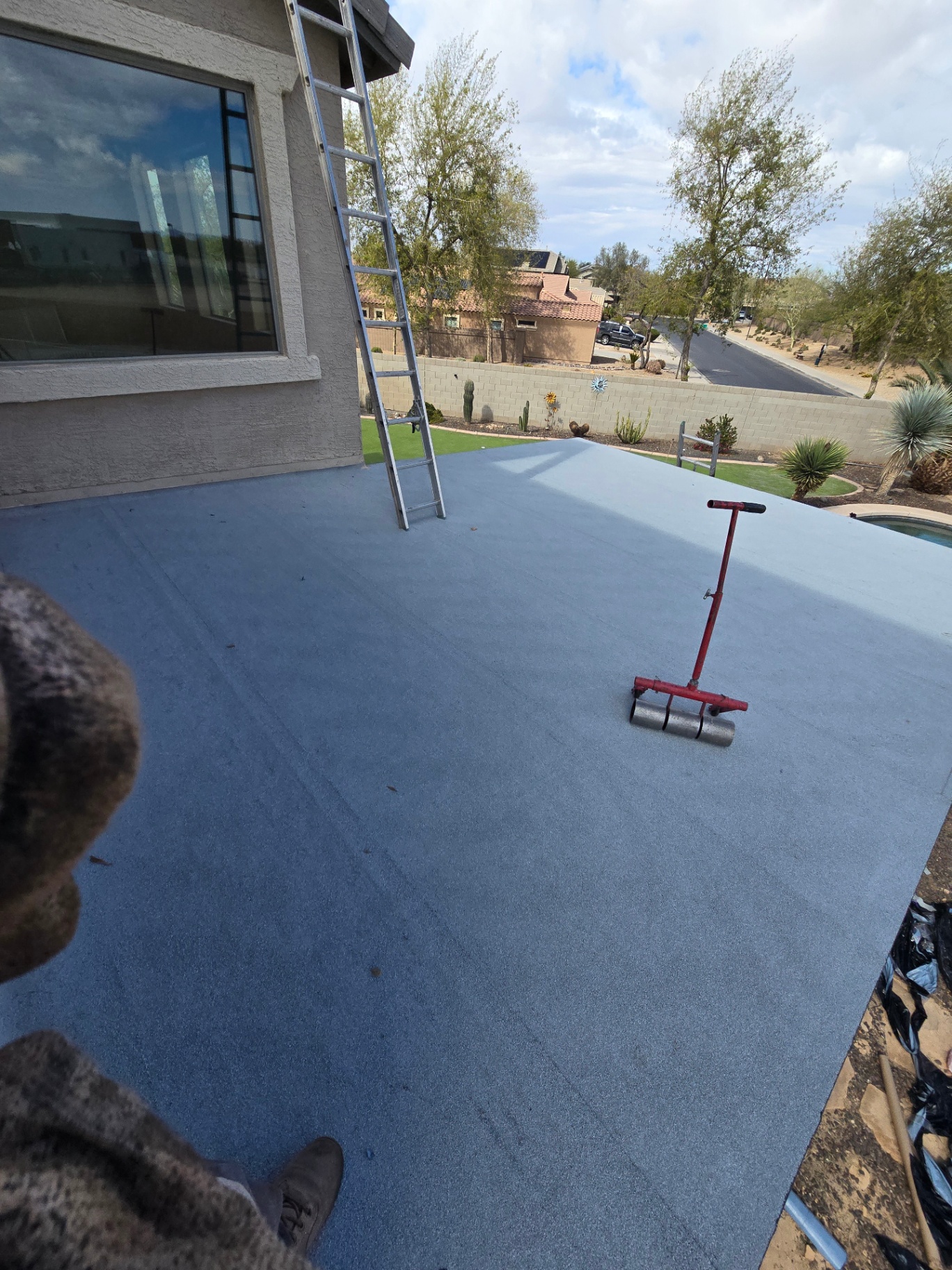Finished patio roof with fresh reflective coating rolled smooth over membrane
