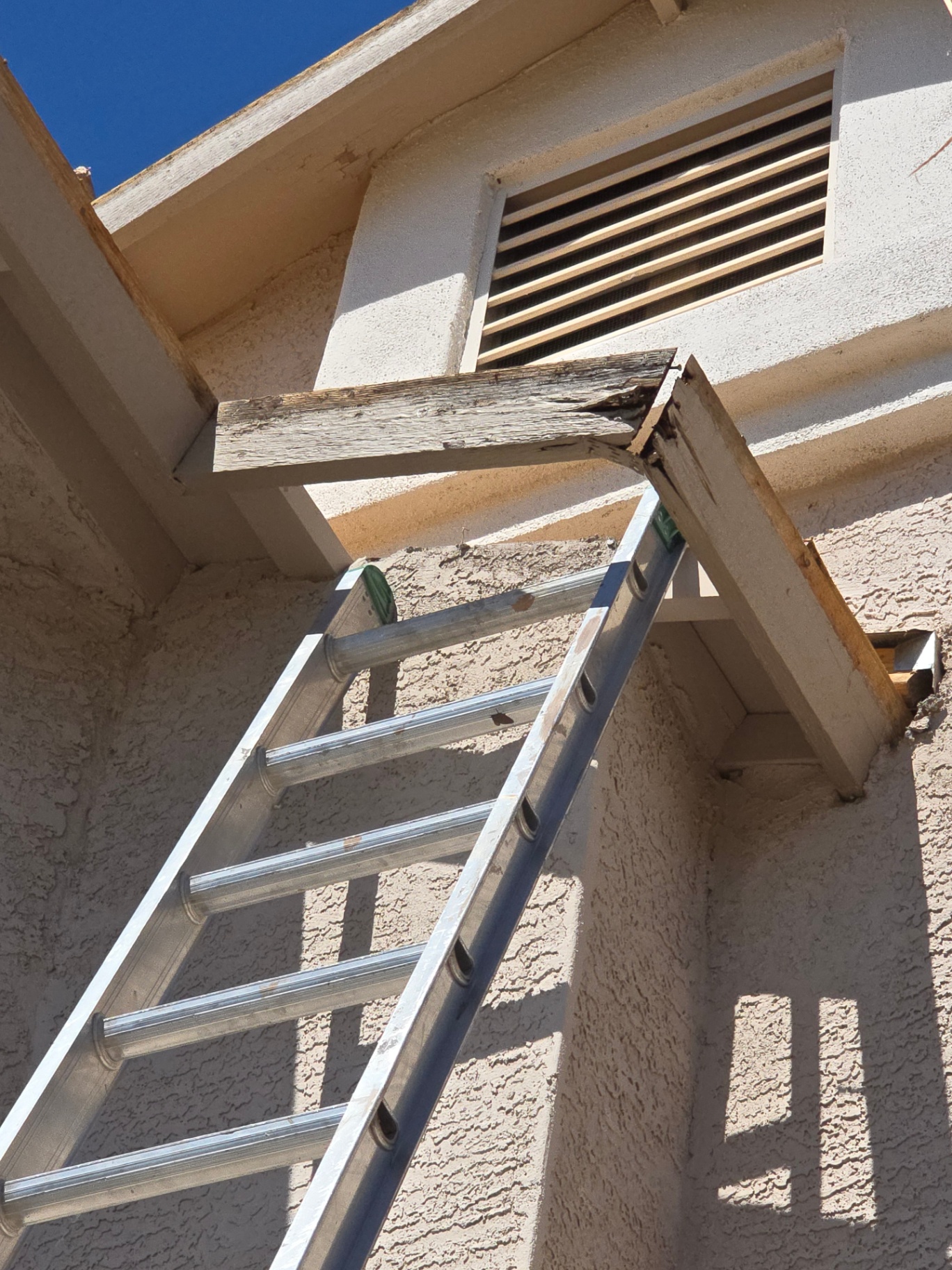 Rotted patio beam and fascia tail uncovered during a structural roof repair