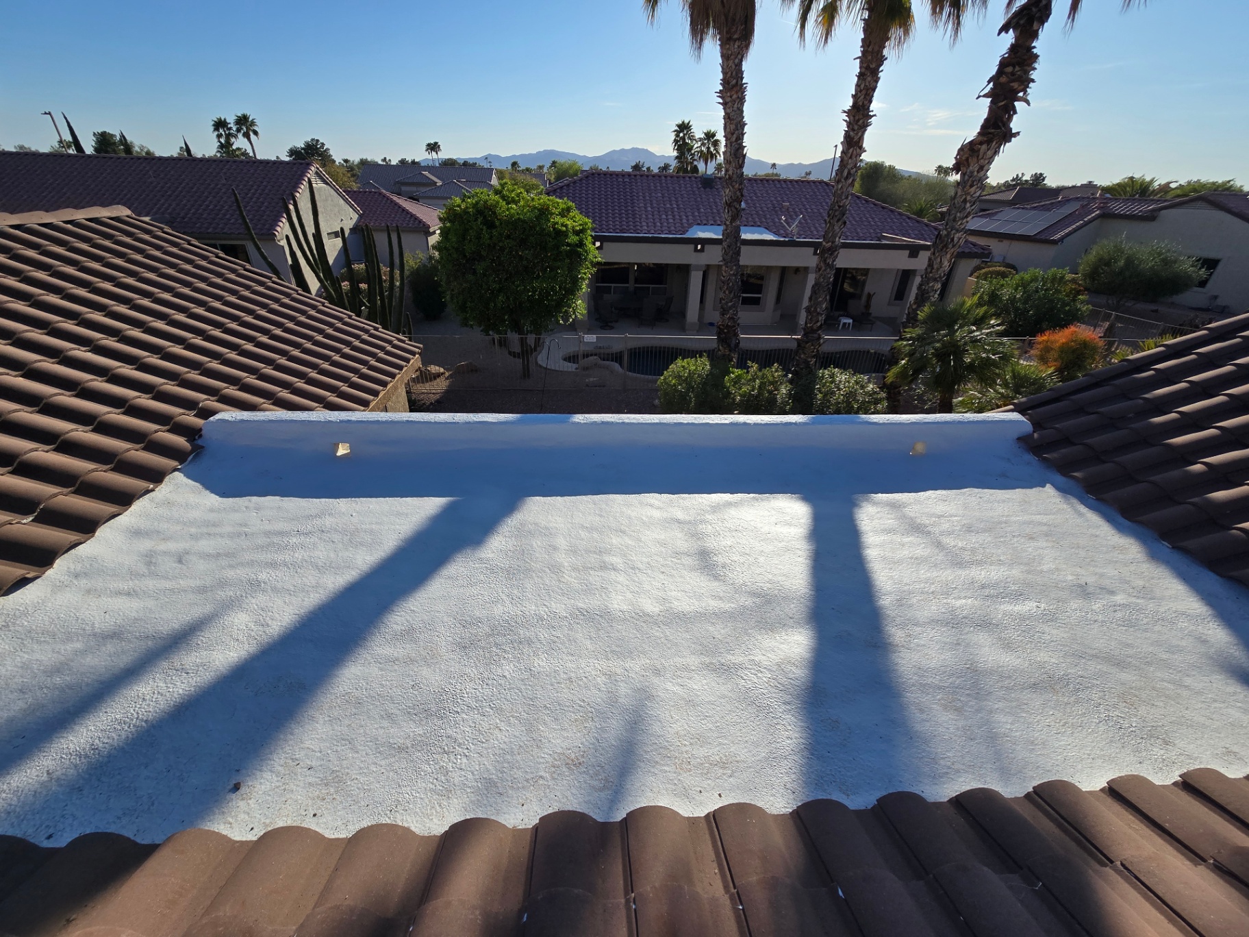 Finished foam and coating job between tile roof sections