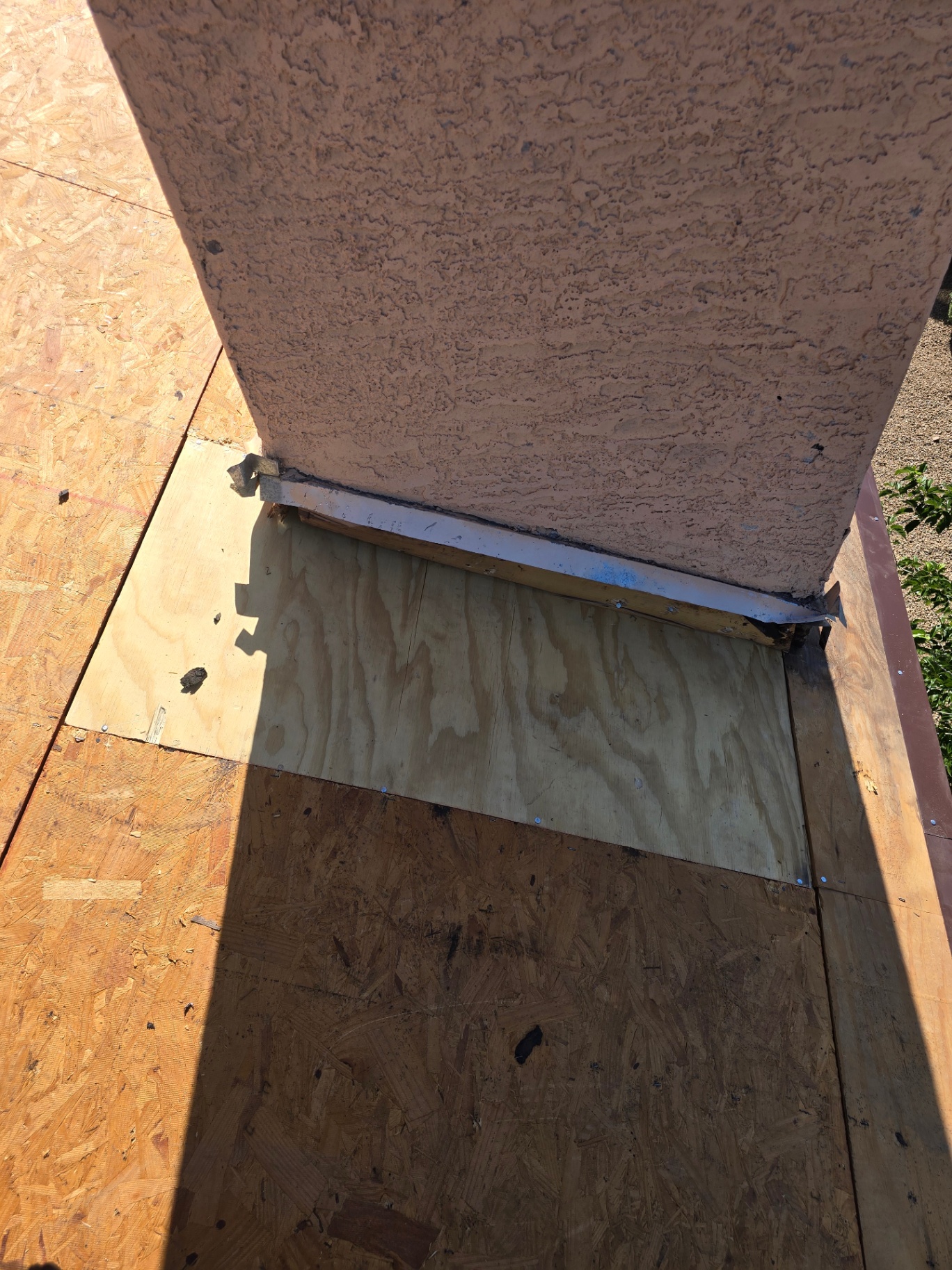 New plywood patch installed at stucco-to-deck transition during a leak repair