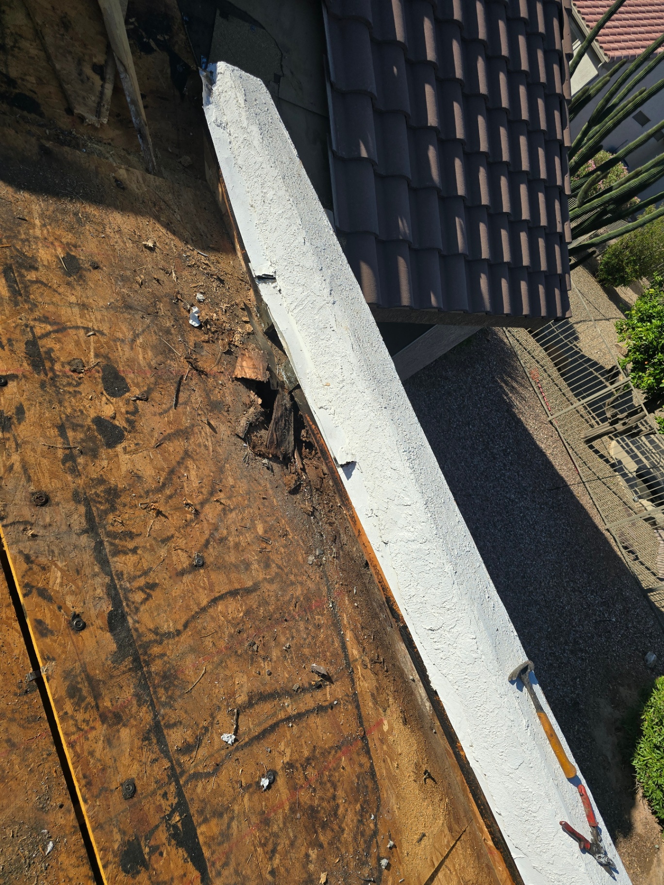 Repaired and coated parapet wall after rotten wood replacement