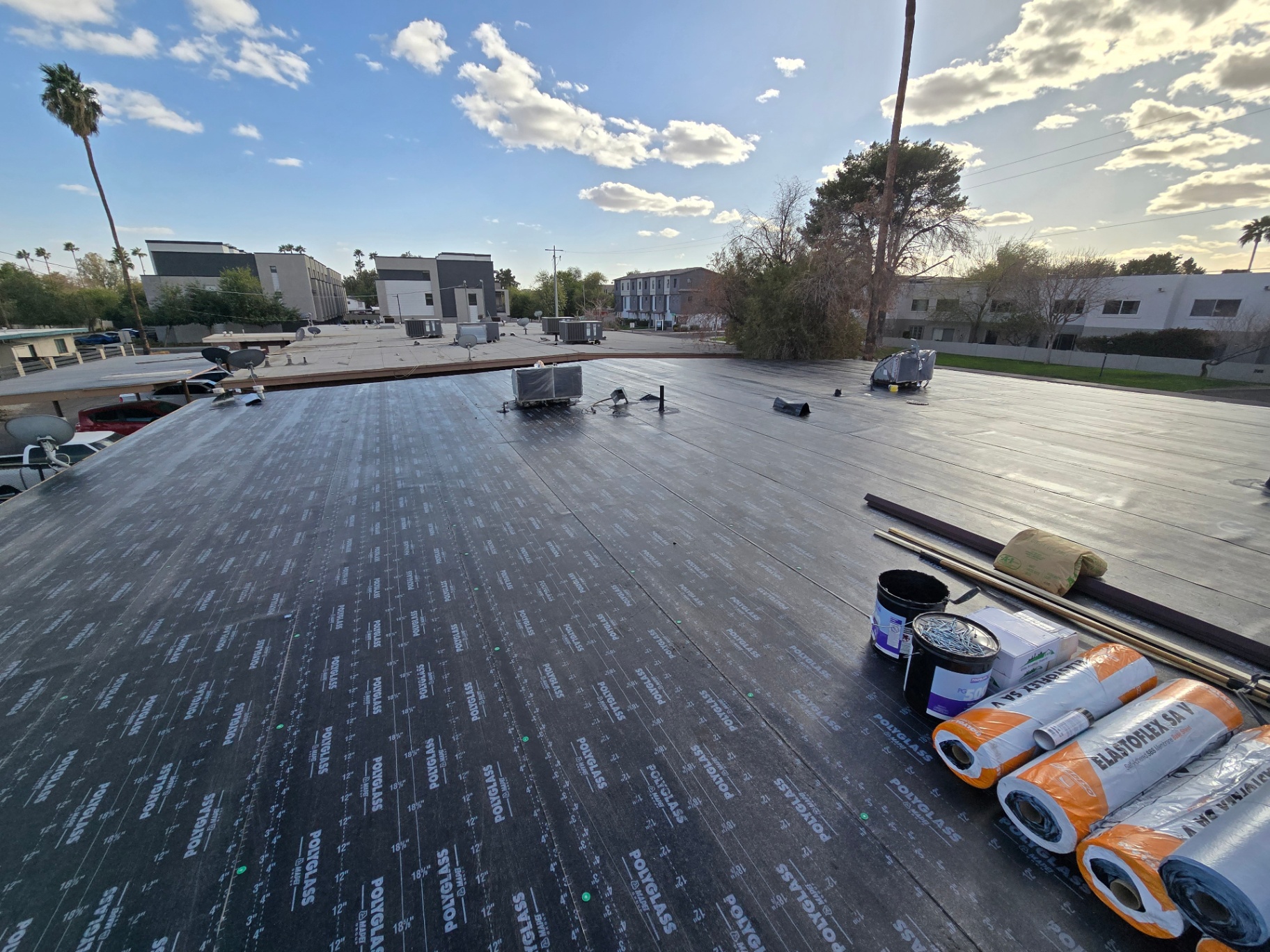 Modified bitumen base sheet laid over wood deck, ready for cap sheet on a flat roof