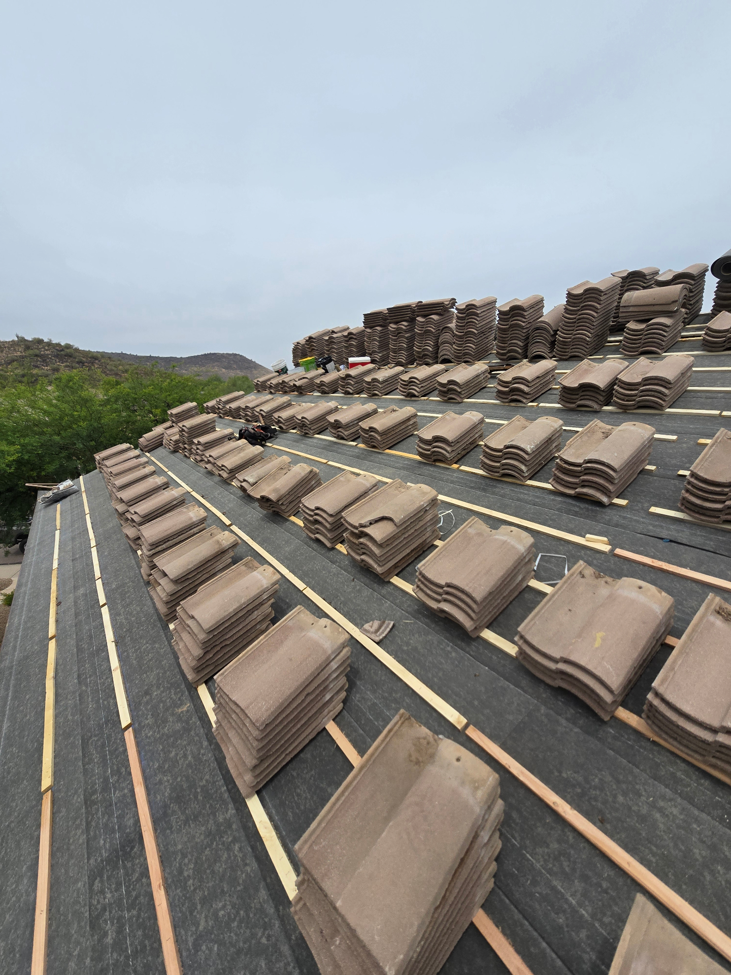 S-tile concrete tiles staged in rows ready for installation