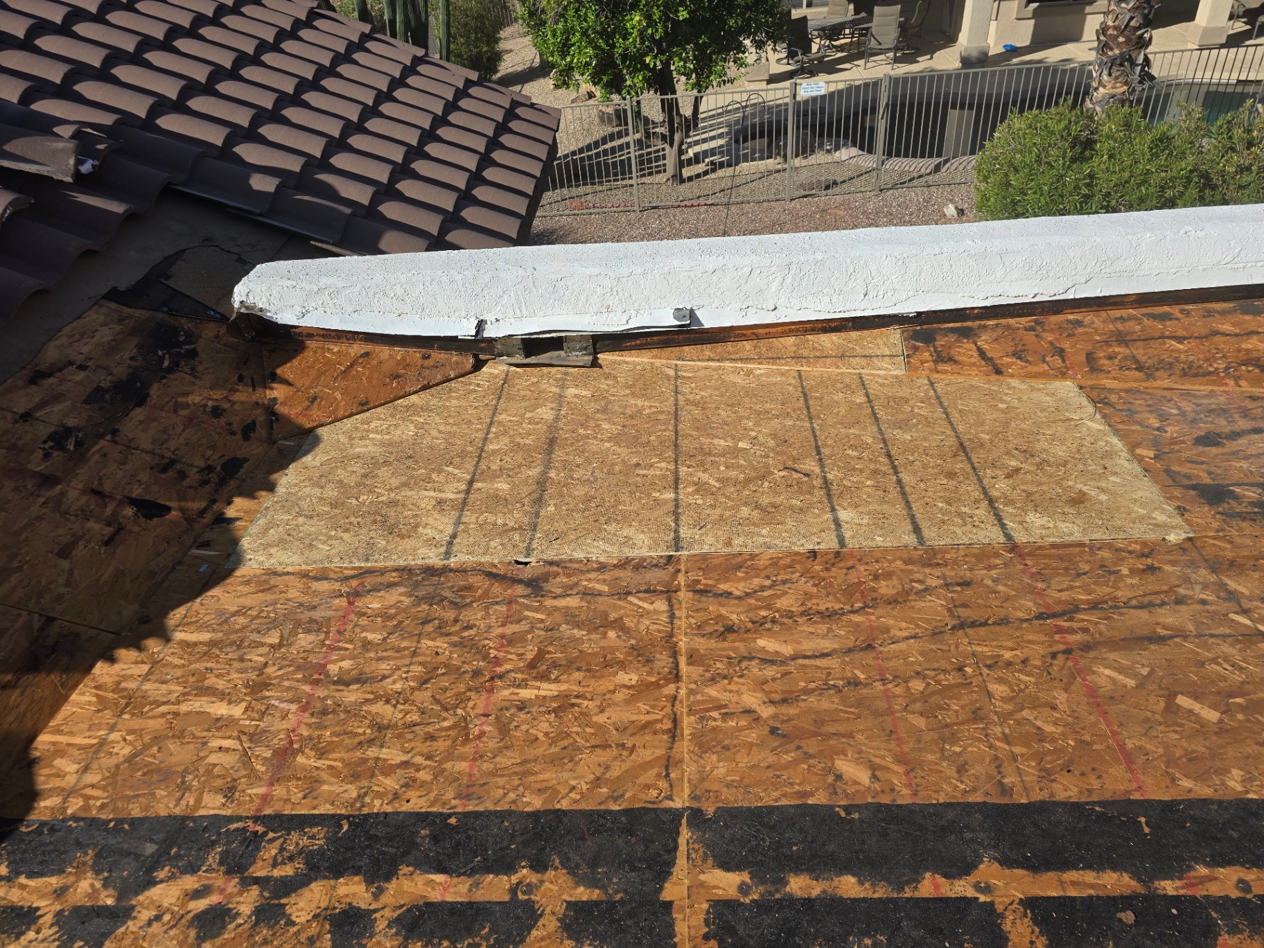 Fresh OSB decking and coated parapet prepped for foam application