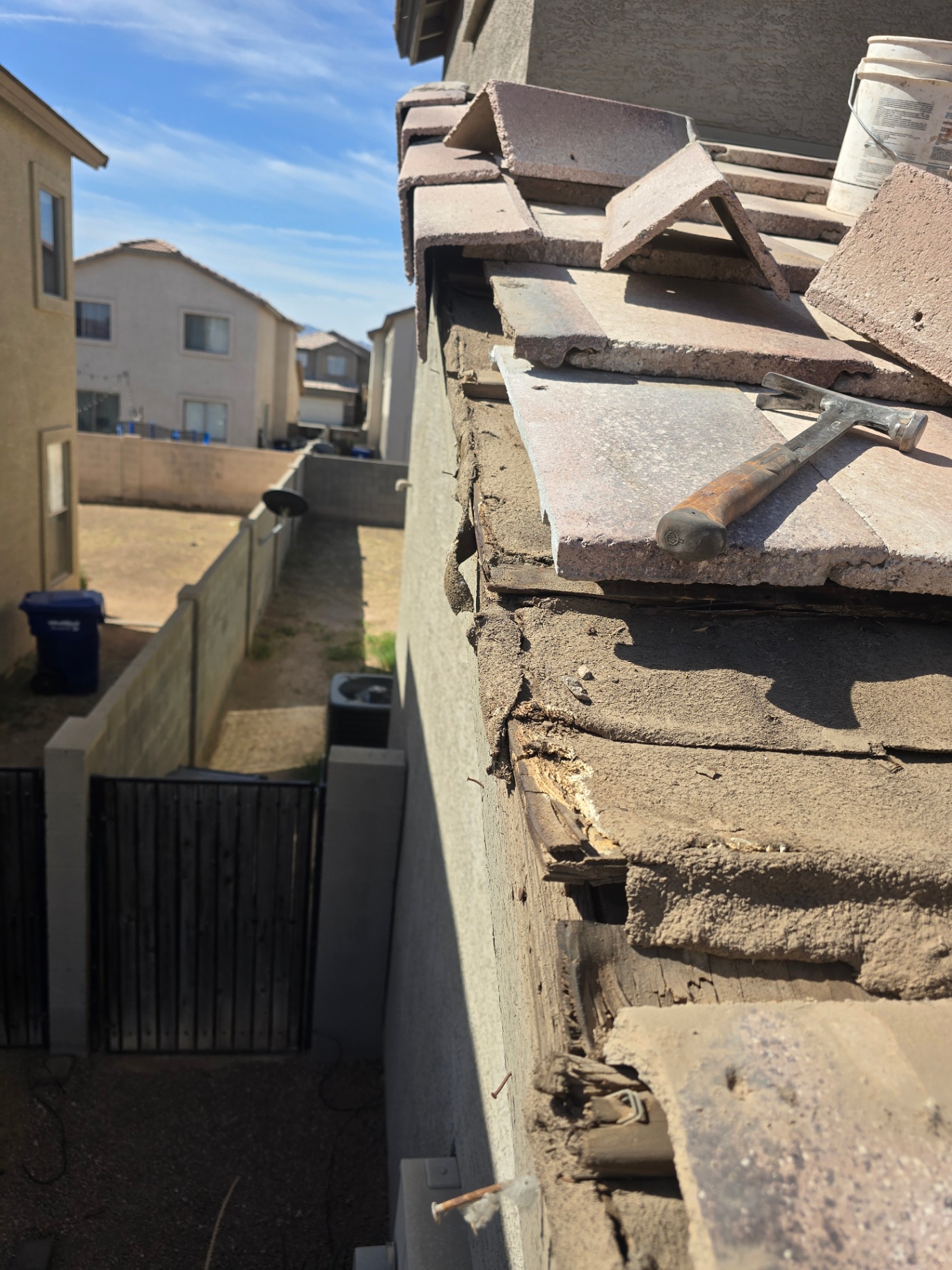 Severe fascia rot under stacked tiles, uncovered during a roof inspection