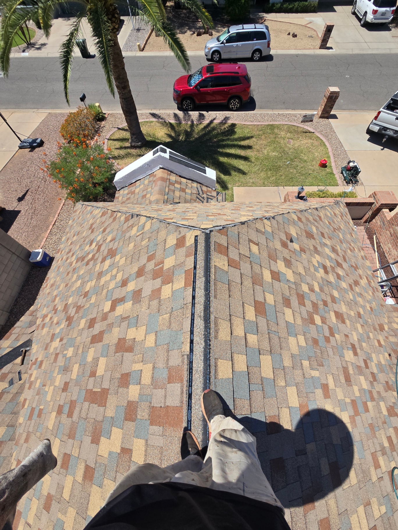 Multi-tone designer shingles with ridge vent installed on a Valley home