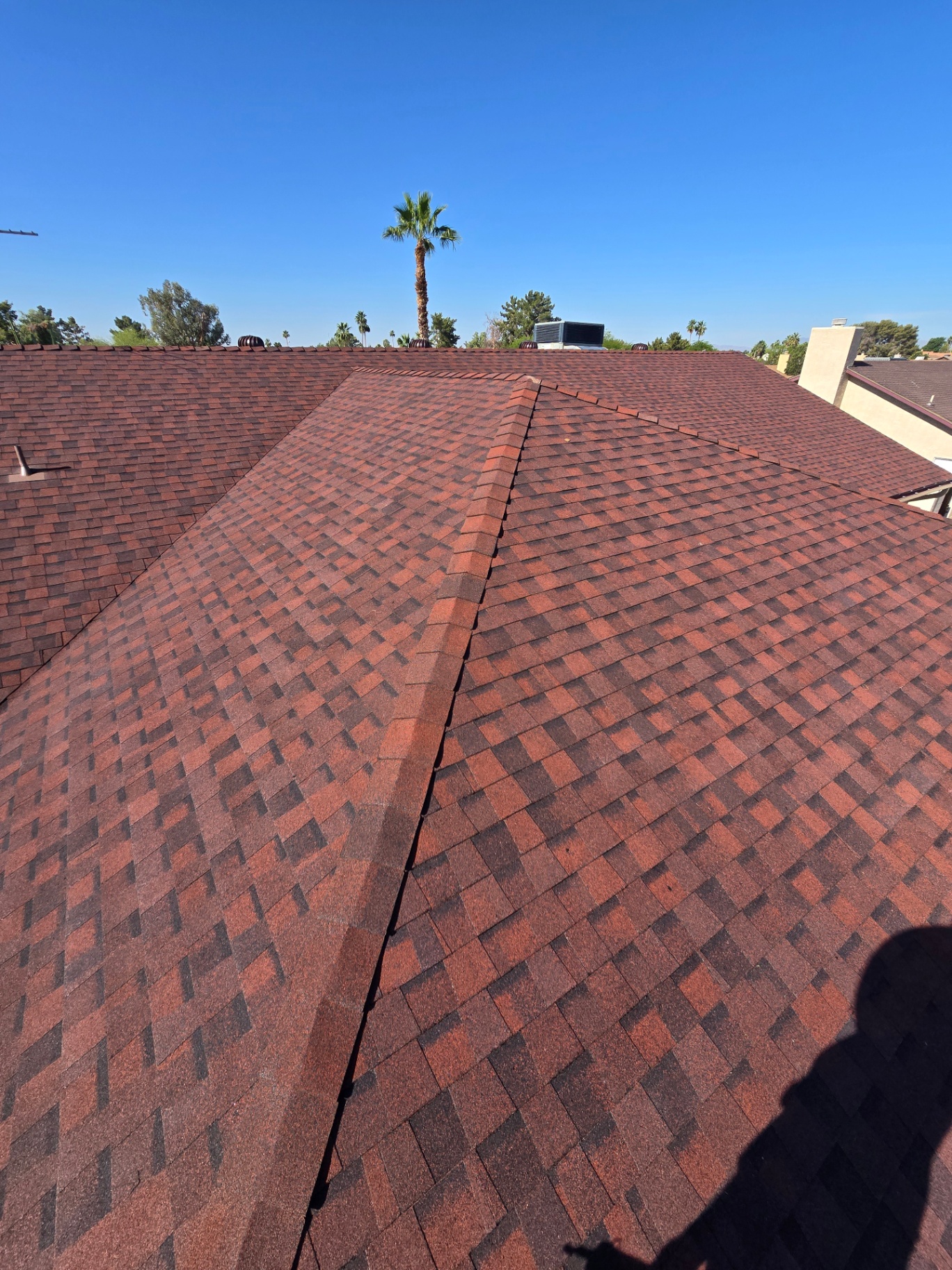 Designer blended-red shingle roof with crisp hip and ridge caps
