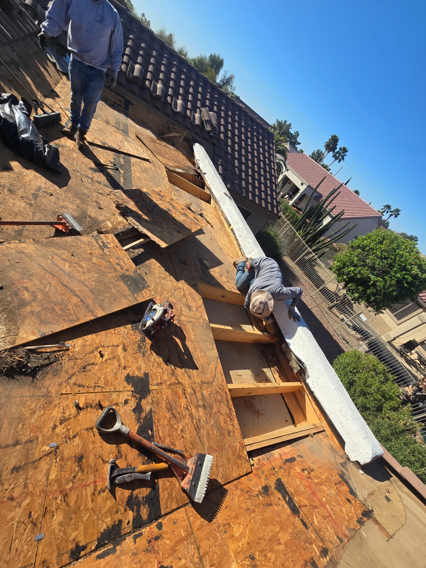 Roof Doc crew rebuilding parapet framing during a foam recoat project