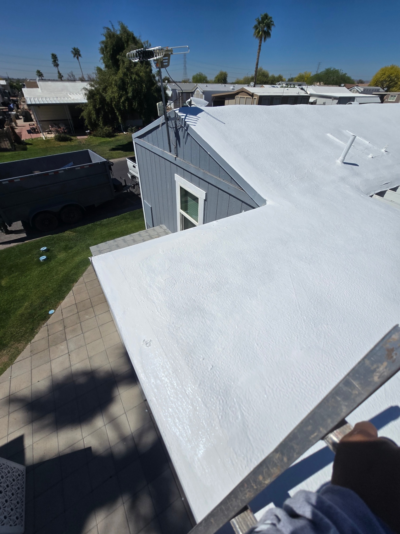Freshly coated flat roof with bright white reflective elastomeric top coat