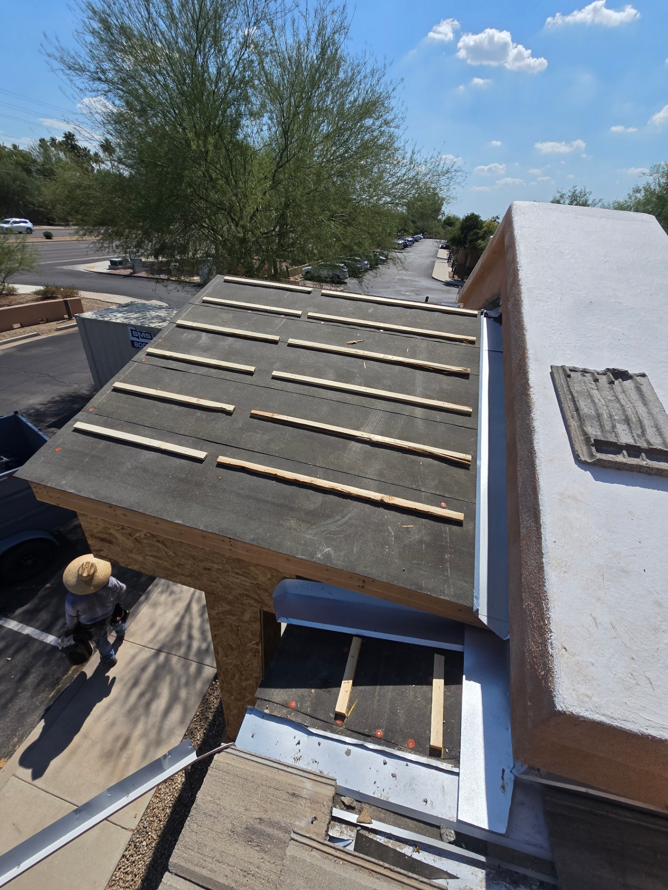 Parapet wall rebuild with new OSB decking and fresh underlayment over a flat roof section