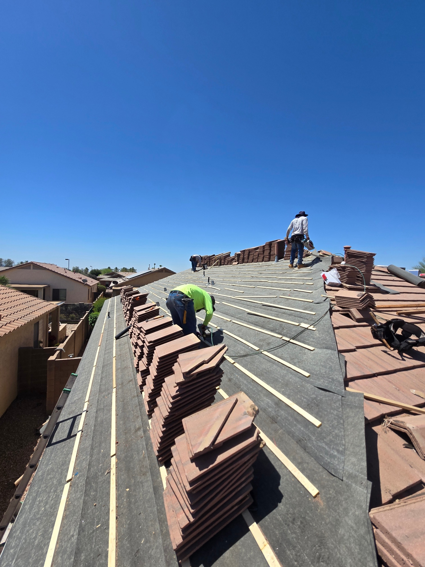 Roof Doc crew loading and laying tile over fresh underlayment