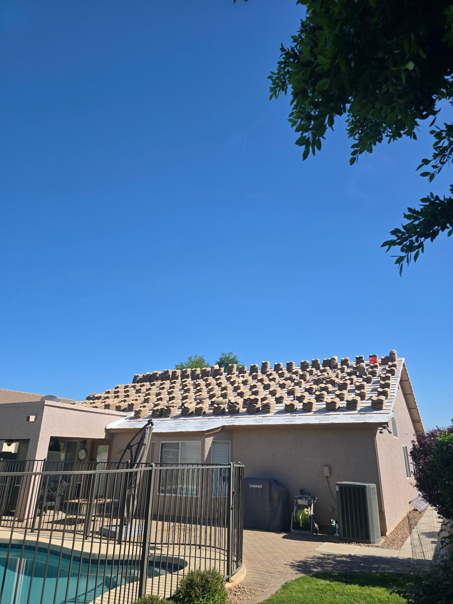Tile roof in progress with stacks of tile ready to be laid